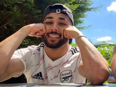 Chaneil Kular is wearing an away kit that is white with some designs in red.